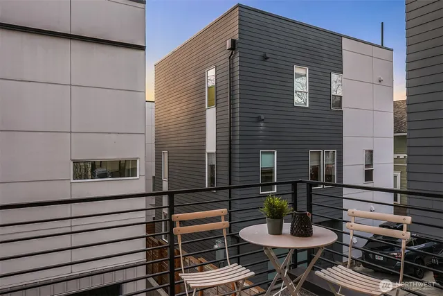 a view of a patio with dining table and chairs