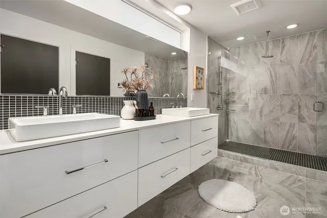 a bathroom with double sink and a mirror