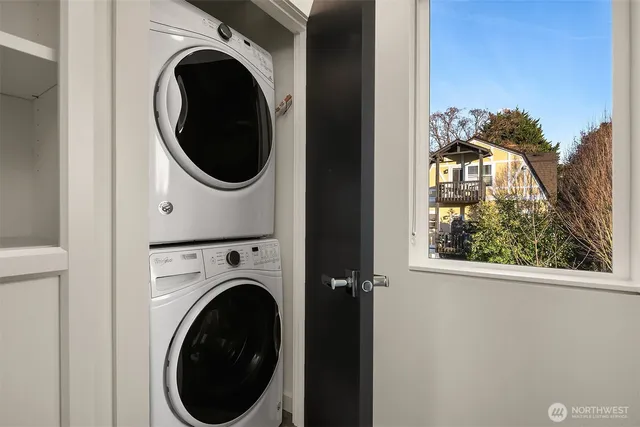 a view of a hallway with washer and dryer