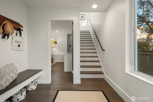 a view of entryway and hall with wooden floor