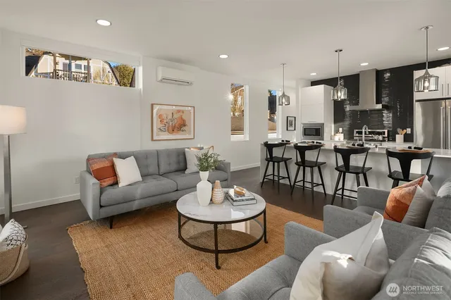 a living room with furniture kitchen and a table