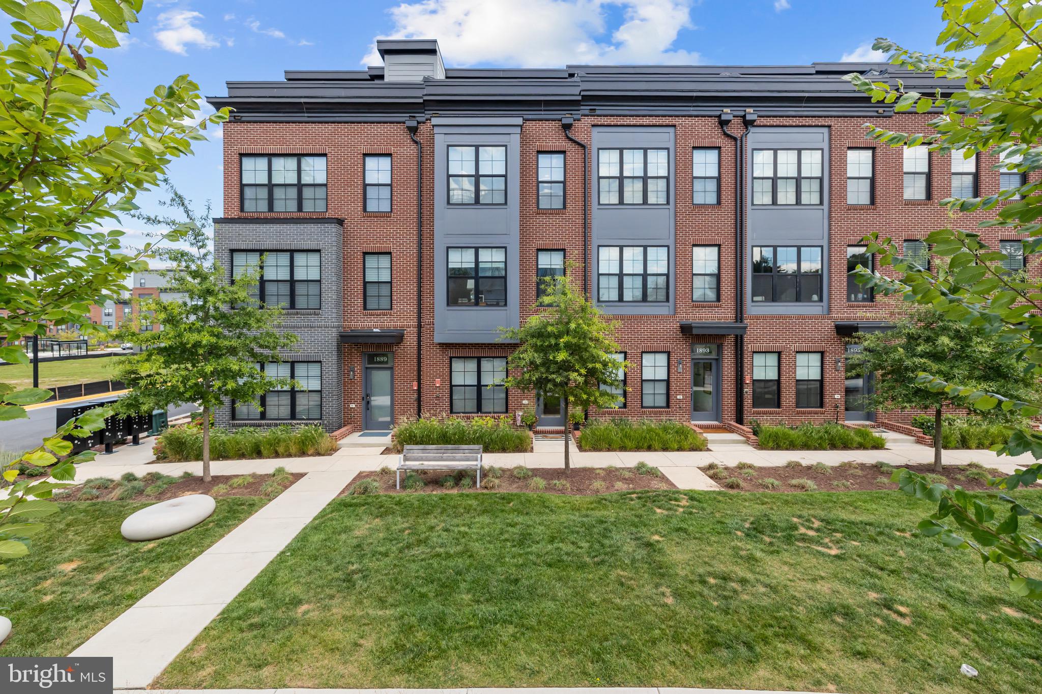 a view of a brick building next to a yard