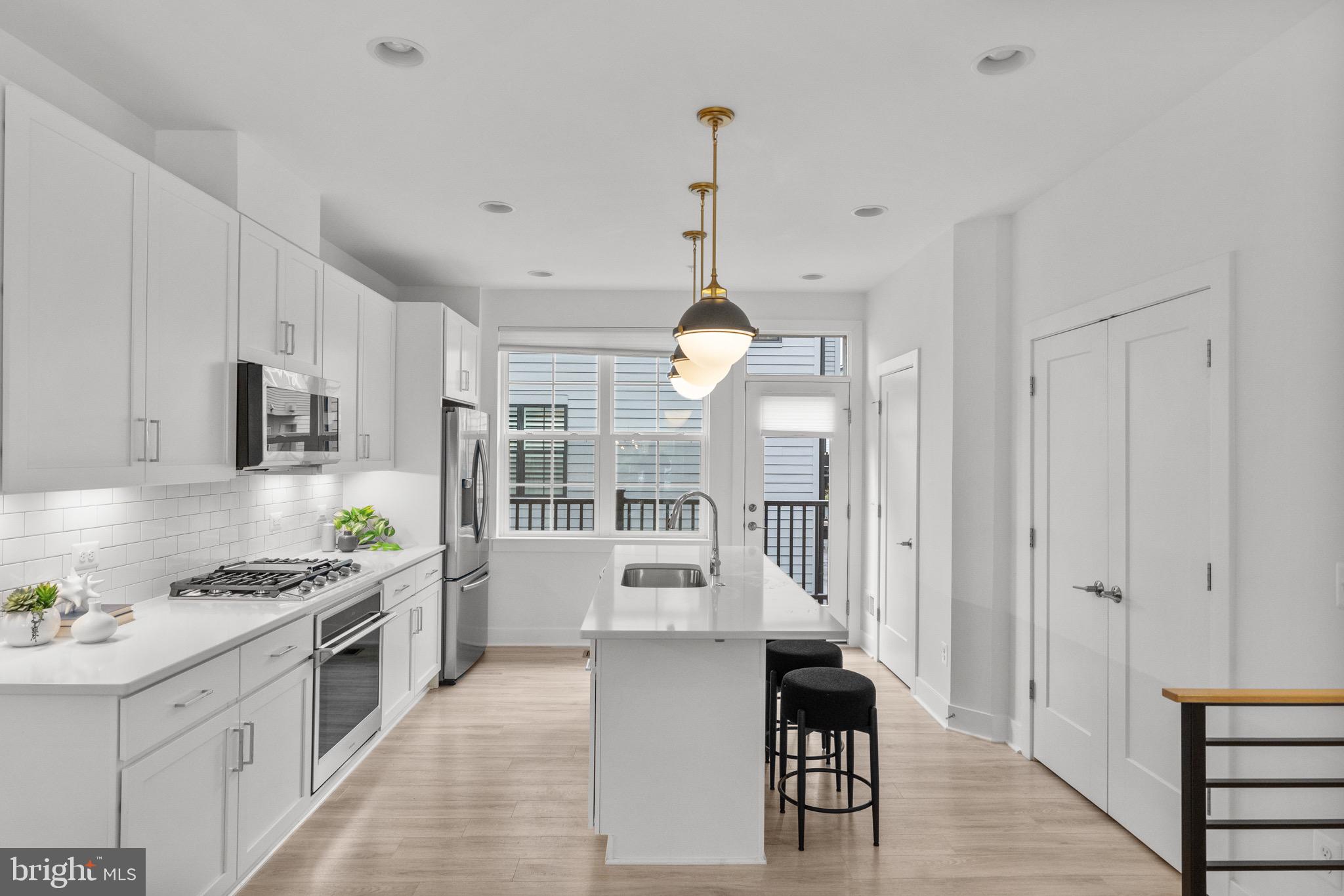 1891 Midline Avenue Reston, VA 20190 - Photo 14 of 53 a large kitchen with stainless steel appliances kitchen island granite countertop a stove a sink a refrigerator and a dining table with wooden floor