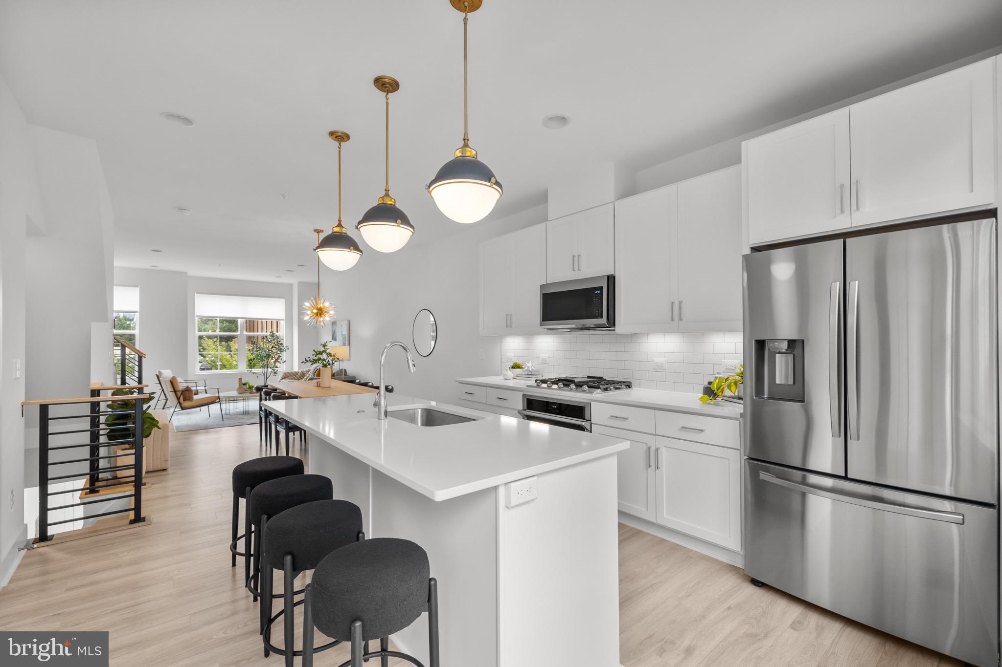 1891 Midline Avenue Reston, VA 20190 - Photo 15 of 53 a kitchen with refrigerator a stove a dining table and chairs with wooden floor