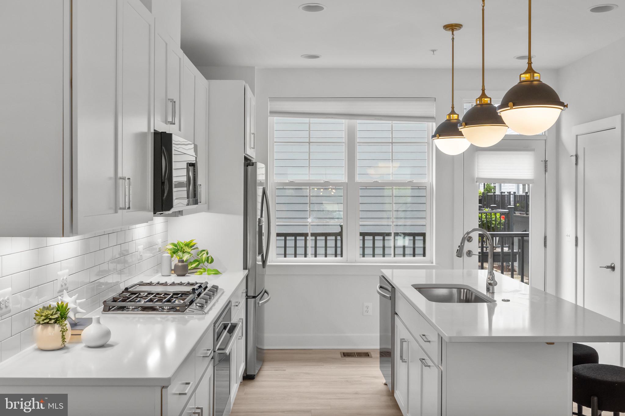 1891 Midline Avenue Reston, VA 20190 - Photo 16 of 53 a kitchen with stainless steel appliances granite countertop a sink a stove and a refrigerator