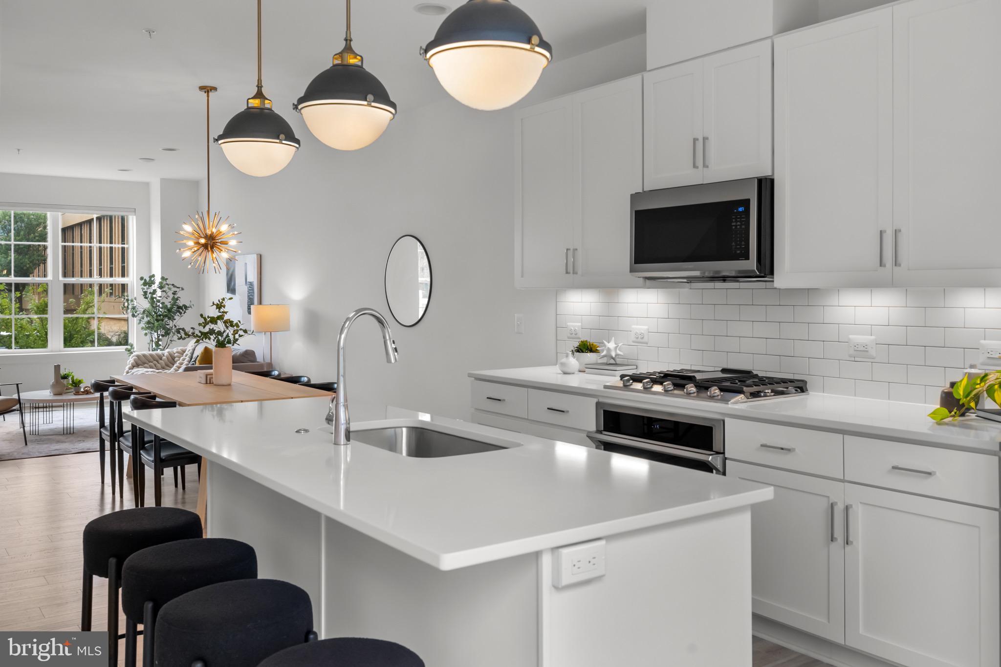 1891 Midline Avenue Reston, VA 20190 - Photo 17 of 53 a kitchen with a sink a stove and a microwave