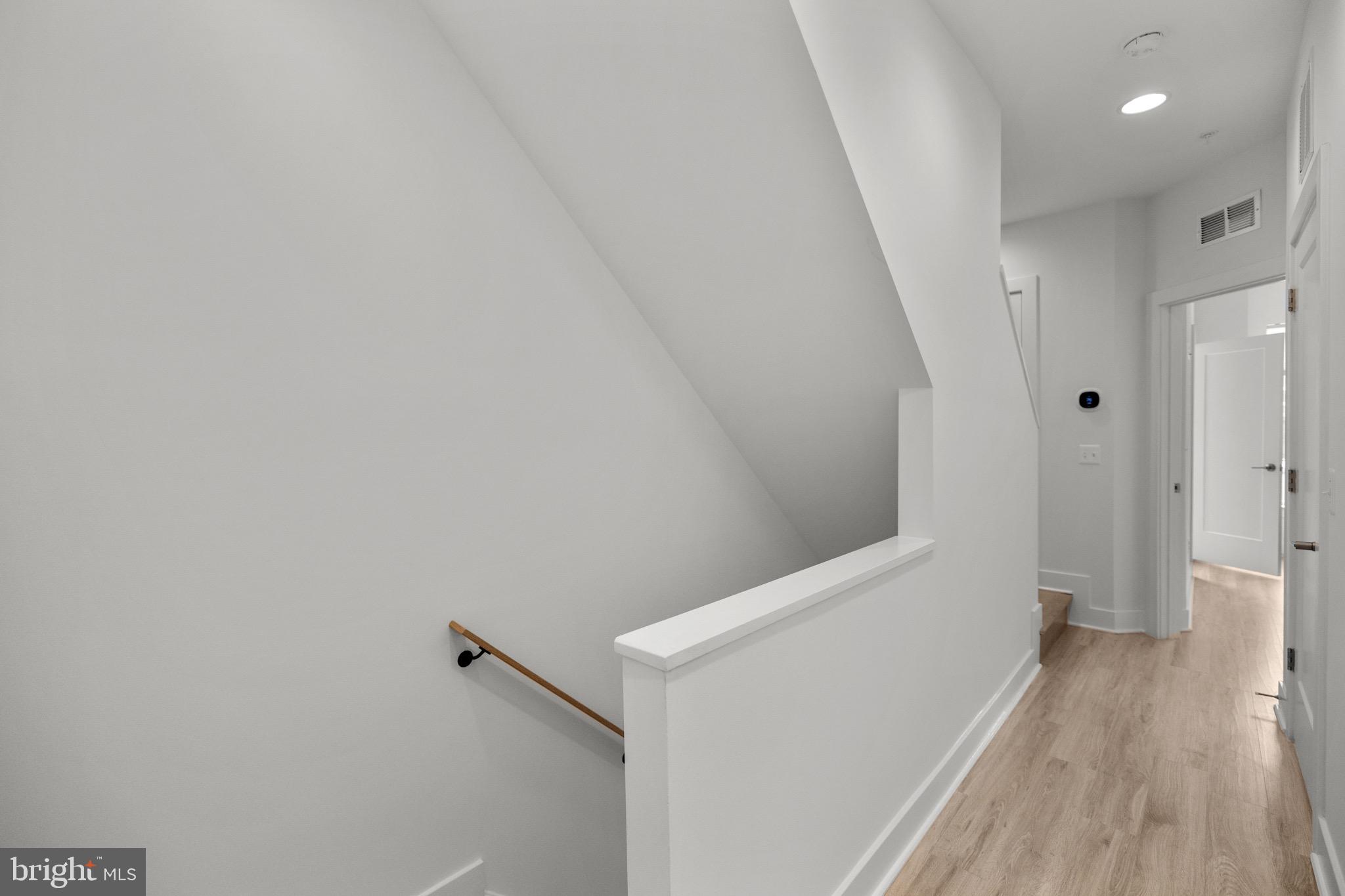 1891 Midline Avenue Reston, VA 20190 - Photo 26 of 53 a view of hallway with stairs and wooden floor