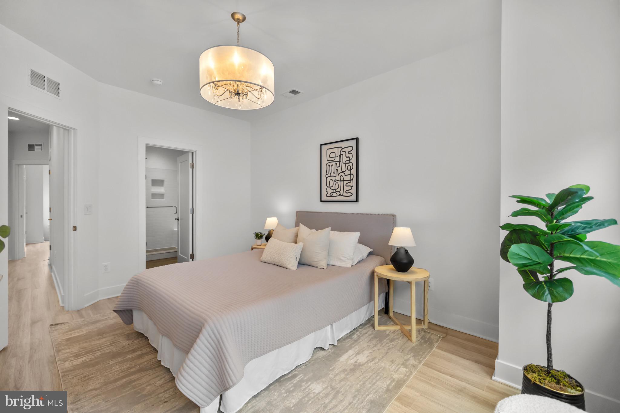 1891 Midline Avenue Reston, VA 20190 - Photo 27 of 53 a bedroom with a bed and a potted plant