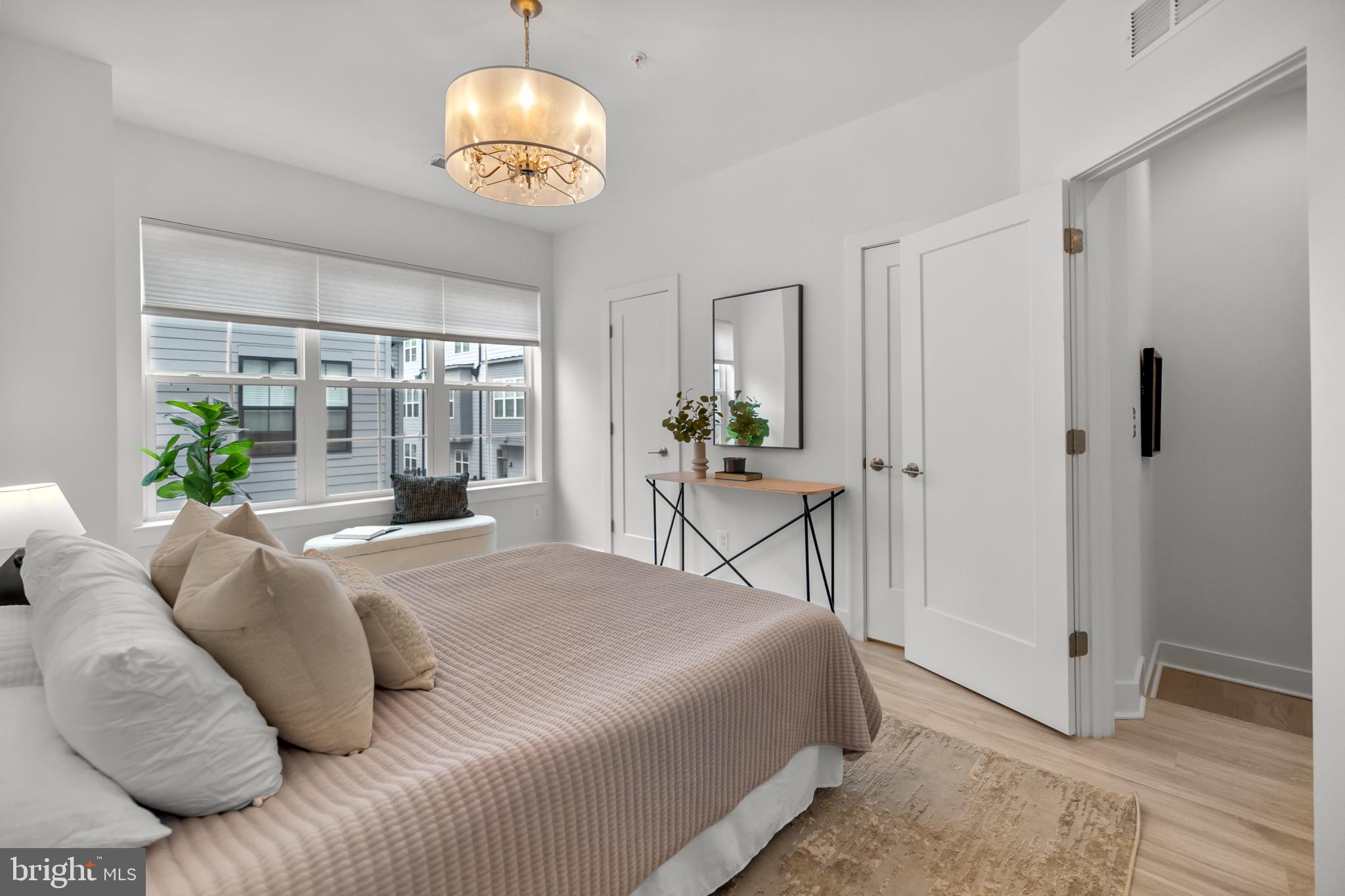 1891 Midline Avenue Reston, VA 20190 - Photo 28 of 53 a bedroom with a bed and a chandelier