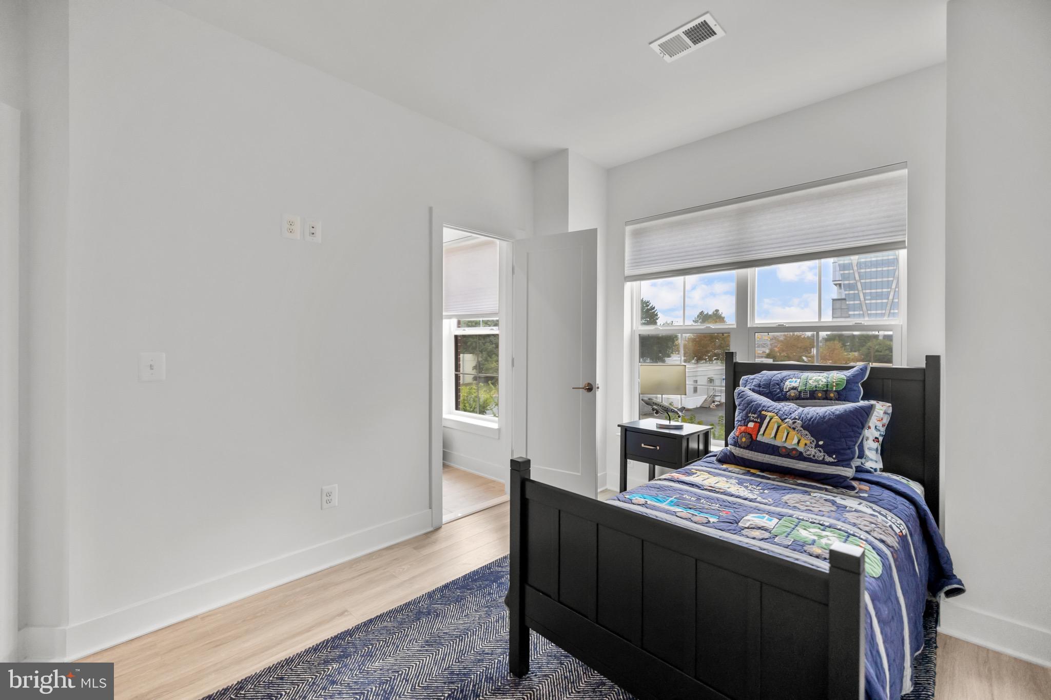 1891 Midline Avenue Reston, VA 20190 - Photo 32 of 53 a bedroom with a bed and wooden floor