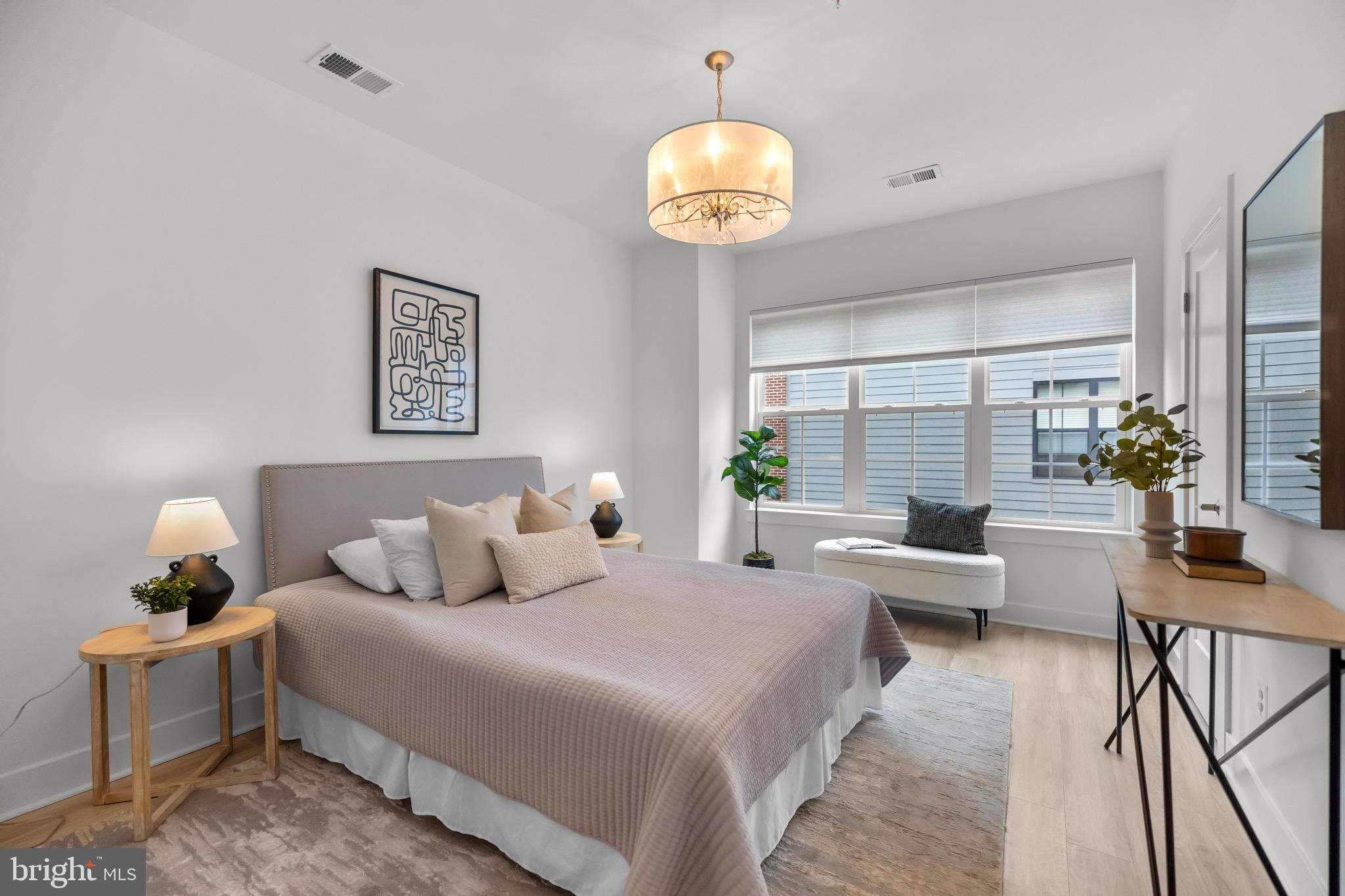 1891 Midline Avenue Reston, VA 20190 - Photo 6 of 53 a bedroom with a bed and a chandelier