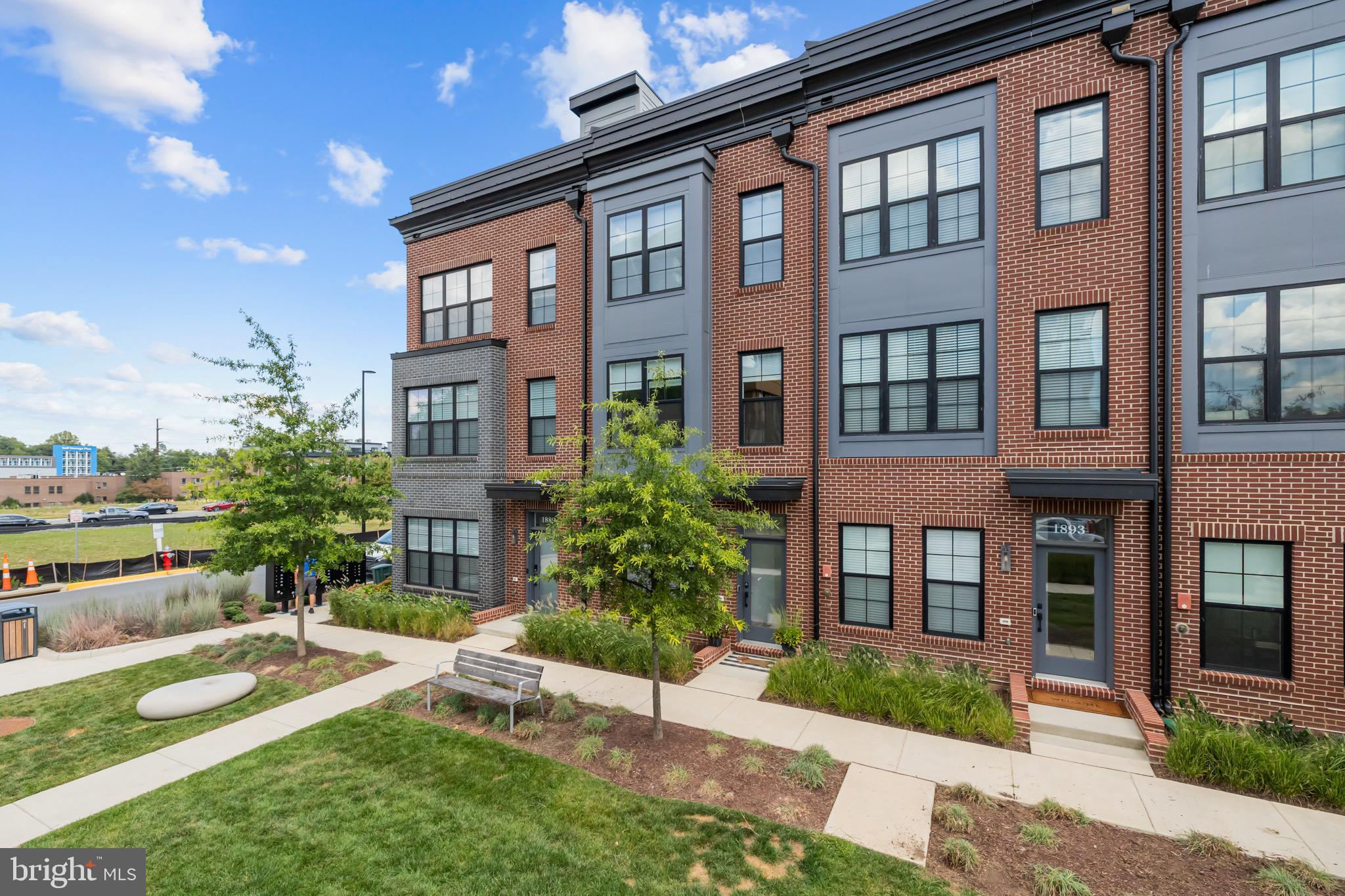 1891 Midline Avenue Reston, VA 20190 - Photo 8 of 53 a view of a brick building next to a yard