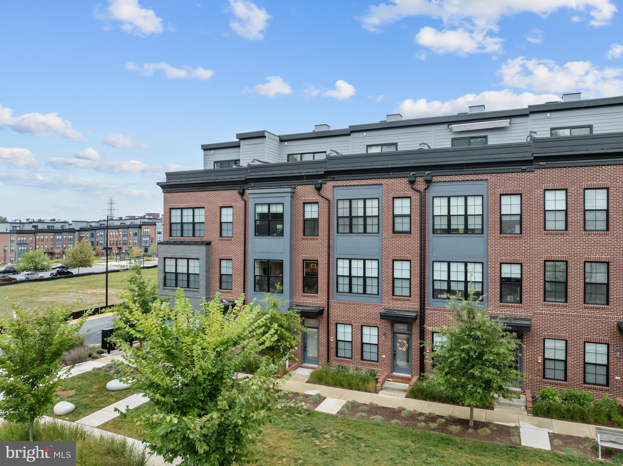 1891 Midline Avenue Reston, VA 20190 - Photo 9 of 53 a front view of a residential apartment building with a yard