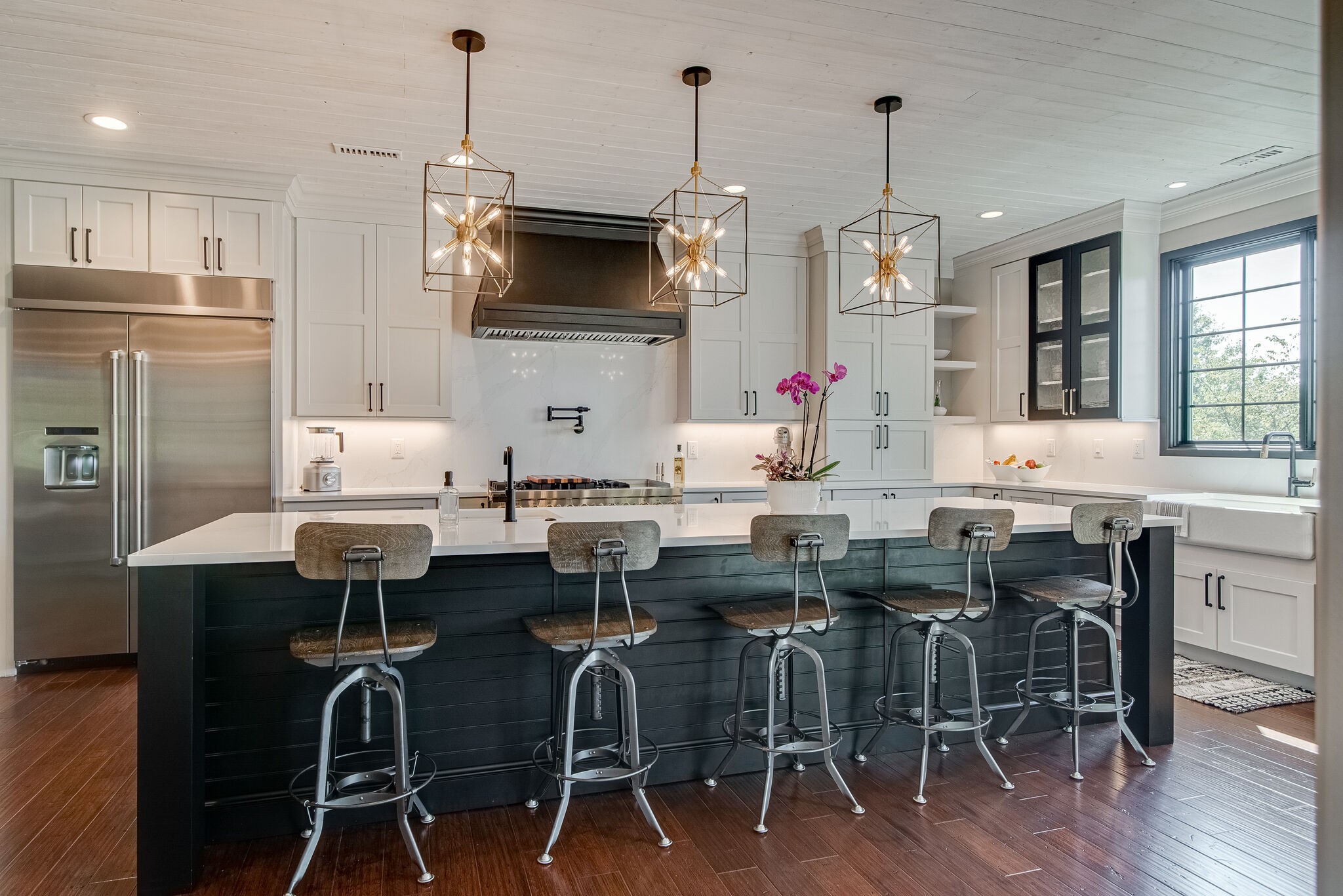297 Vanderbilt Road Mount Juliet, TN 37122 - Photo 11 of 50 a kitchen with stainless steel appliances granite countertop a dining table chairs stove refrigerator and microwave