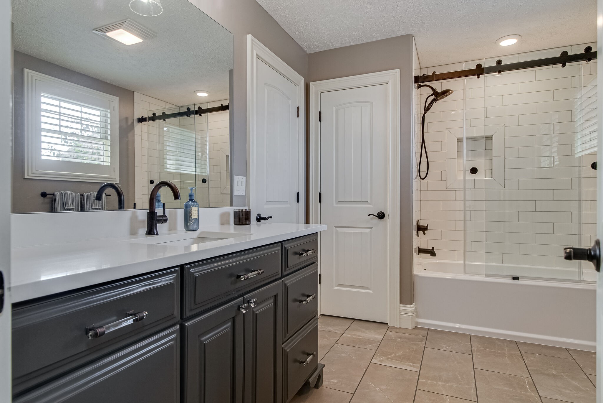 297 Vanderbilt Road Mount Juliet, TN 37122 - Photo 27 of 50 a bathroom with a double vanity sink a mirror a bathtub and shower