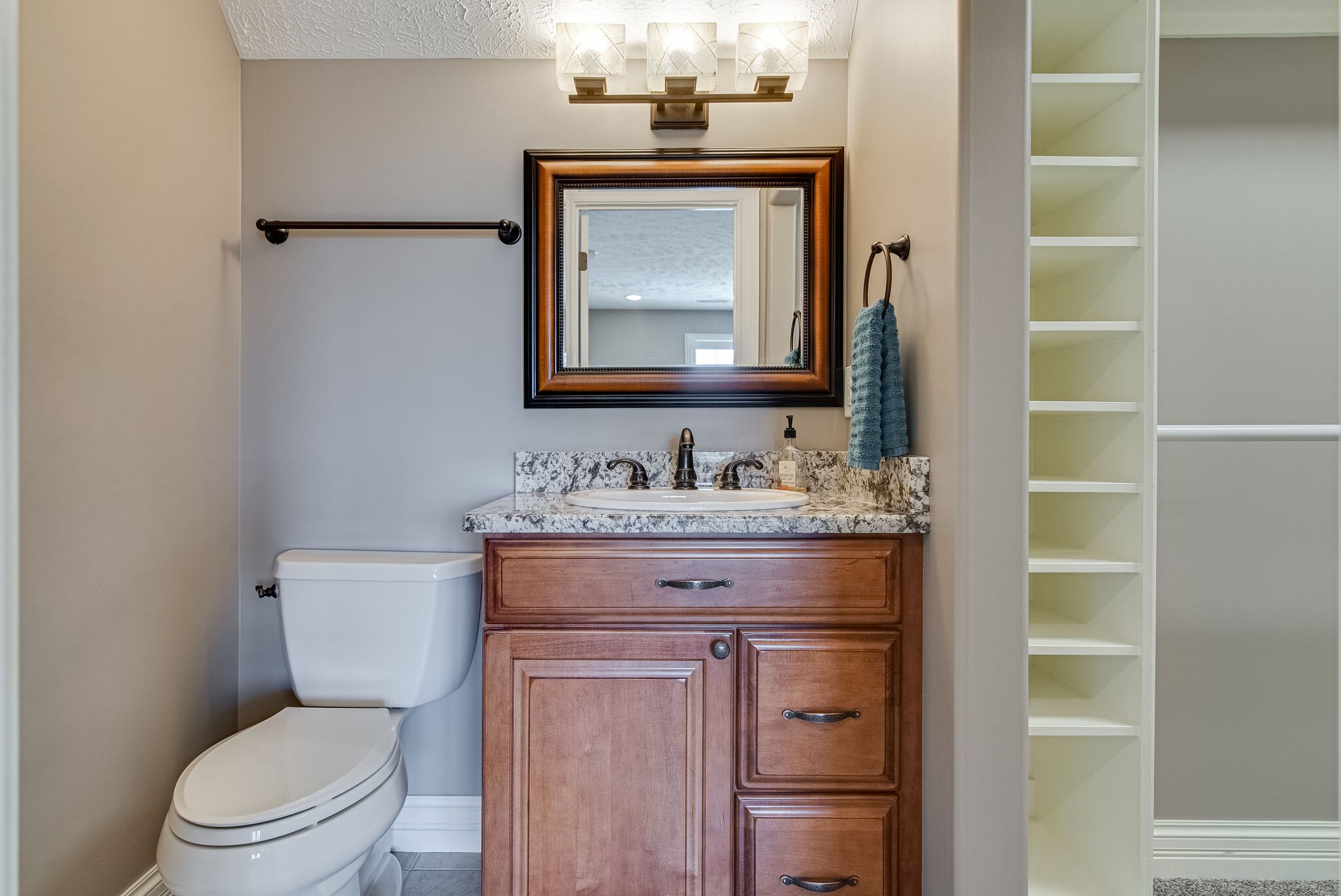 297 Vanderbilt Road Mount Juliet, TN 37122 - Photo 38 of 50 a bathroom with a granite countertop toilet a sink and a mirror