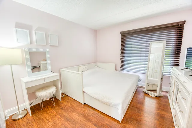 a bed room with a bed and a chair