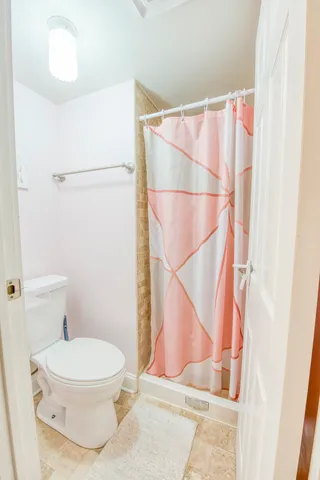 a white toilet sitting next to a bathroom sink
