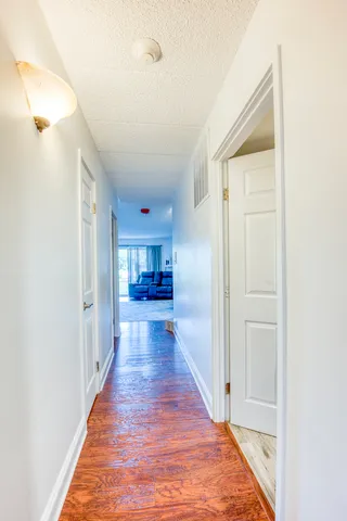 a view of a hallway with wooden floor