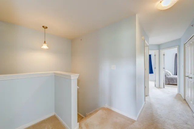 a view of a hallway with wooden shelves