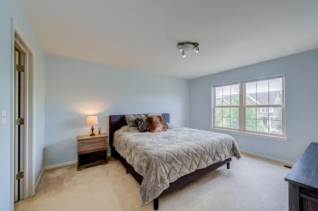a bedroom with a bed and large mirror