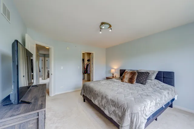 a bedroom with a bed and a television