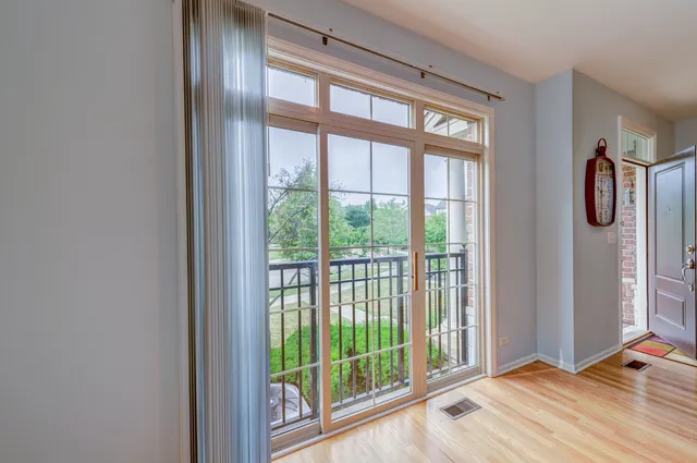 a view of a room that has a bed and wooden floor
