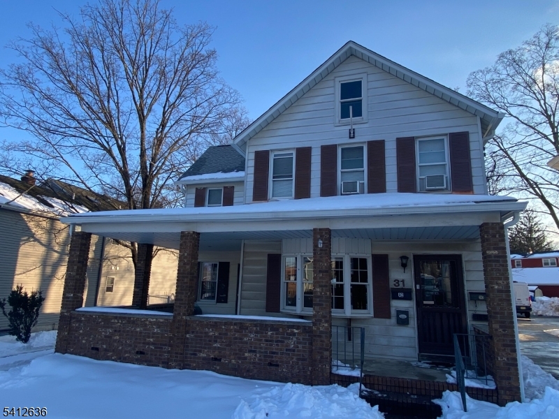 a front view of brick house with large windows