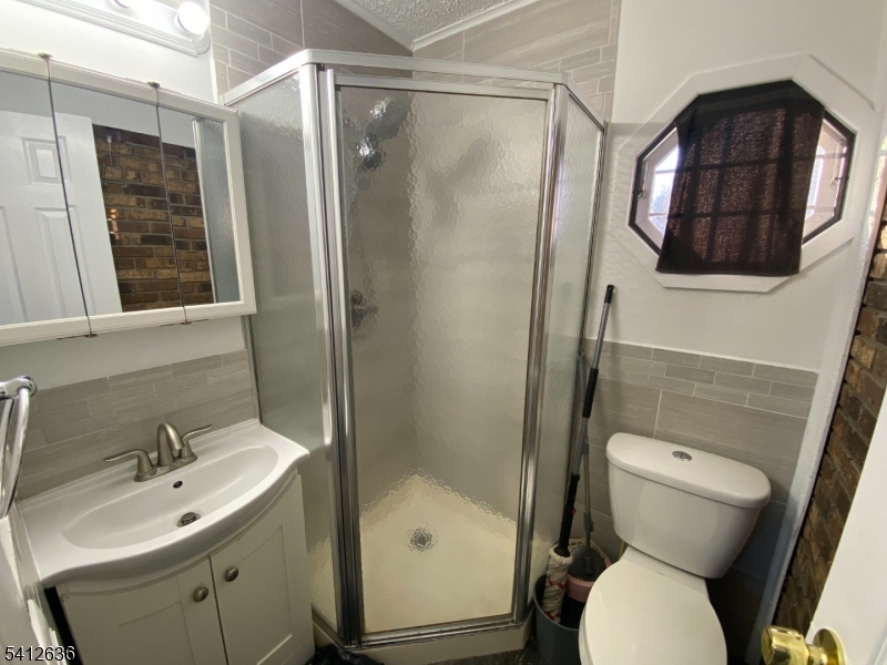 31 Kiel Avenue Butler, NJ 07405 - Photo 13 of 16 a bathroom with a toilet sink and shower