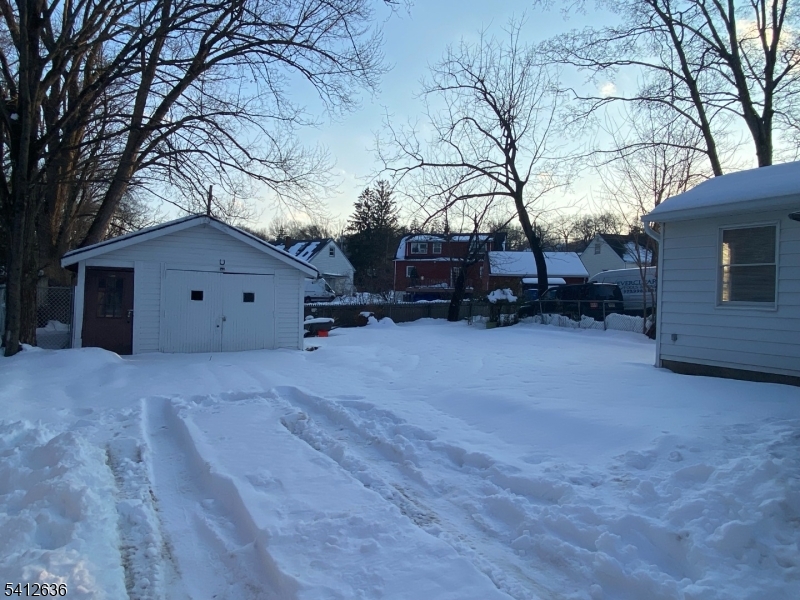 31 Kiel Avenue Butler, NJ 07405 - Photo 15 of 16 a view of a house with a yard covered in snow