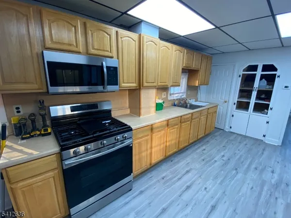 a kitchen with stainless steel appliances a stove a microwave and cabinets