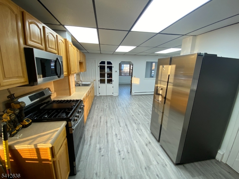 31 Kiel Avenue Butler, NJ 07405 - Photo 4 of 16 a kitchen with stainless steel appliances a refrigerator a stove a microwave and cabinets