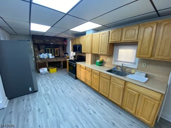 a kitchen with wooden floors wooden cabinets table and chairs