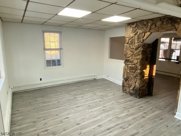 a view of a room with wooden floor