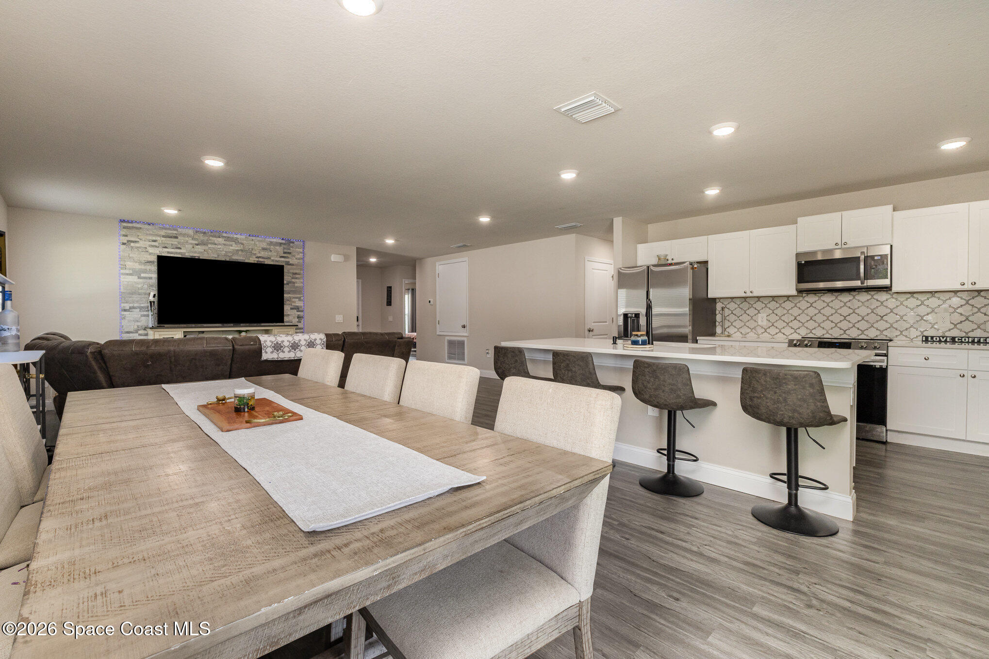 866 Carnival Road Southeast Palm Bay, FL 32909 - Photo 12 of 28 a living room with furniture and kitchen view