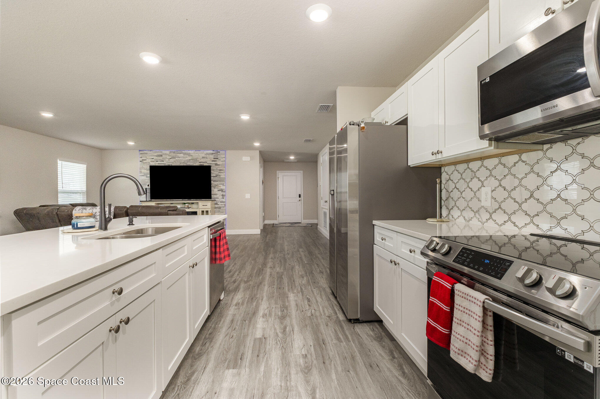 866 Carnival Road Southeast Palm Bay, FL 32909 - Photo 14 of 28 a kitchen with a stove and a microwave