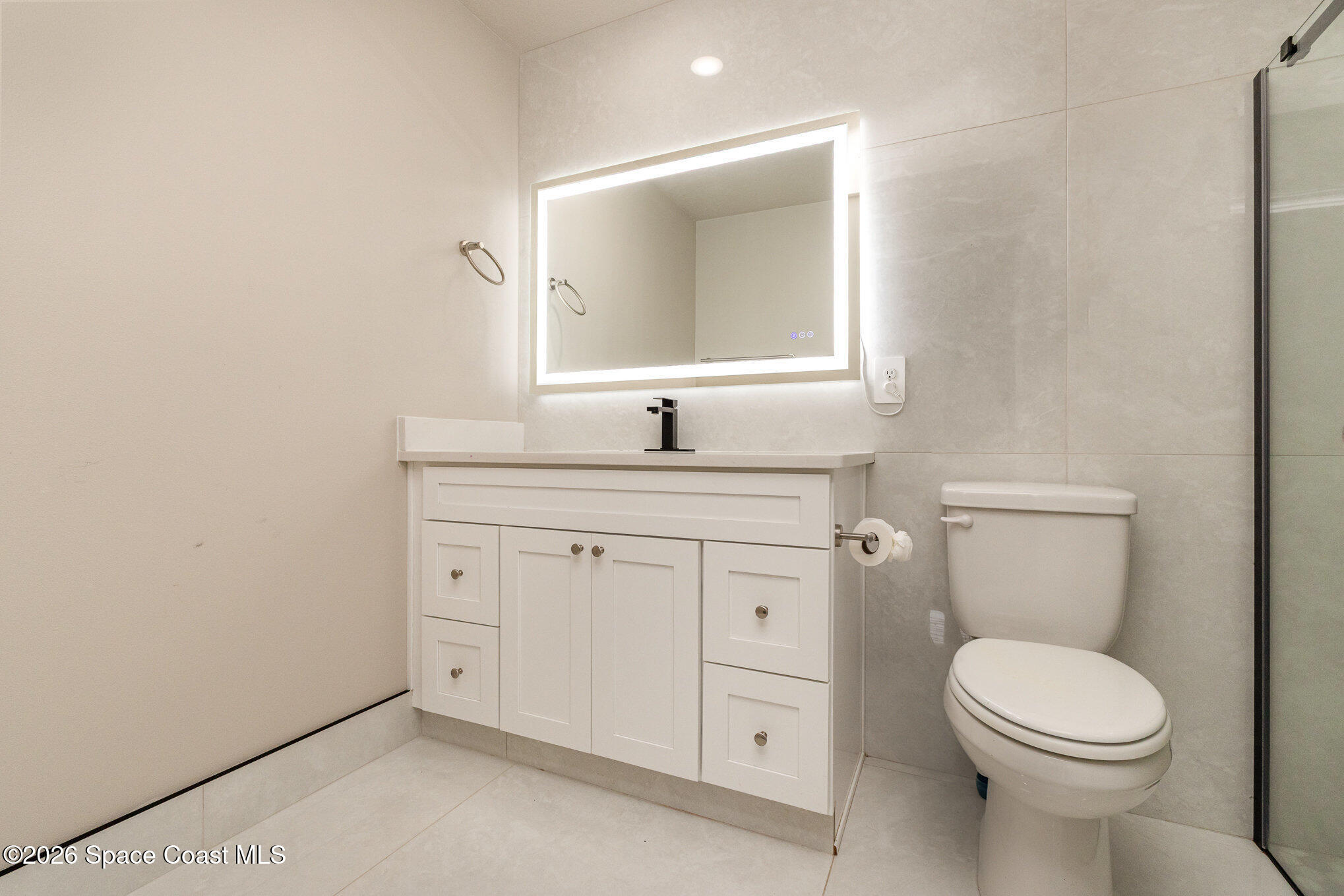866 Carnival Road Southeast Palm Bay, FL 32909 - Photo 21 of 28 a bathroom with a granite countertop toilet sink and mirror