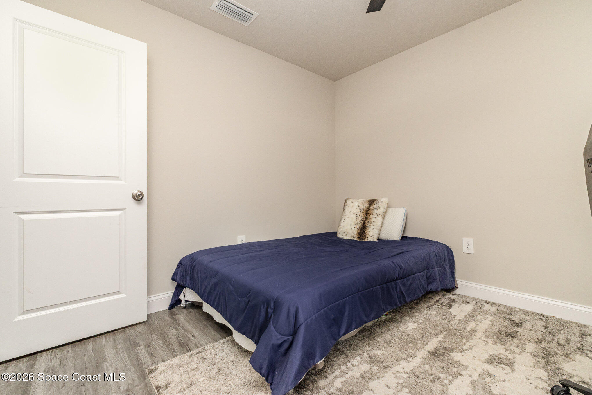 866 Carnival Road Southeast Palm Bay, FL 32909 - Photo 22 of 28 a bedroom with a bed and a window