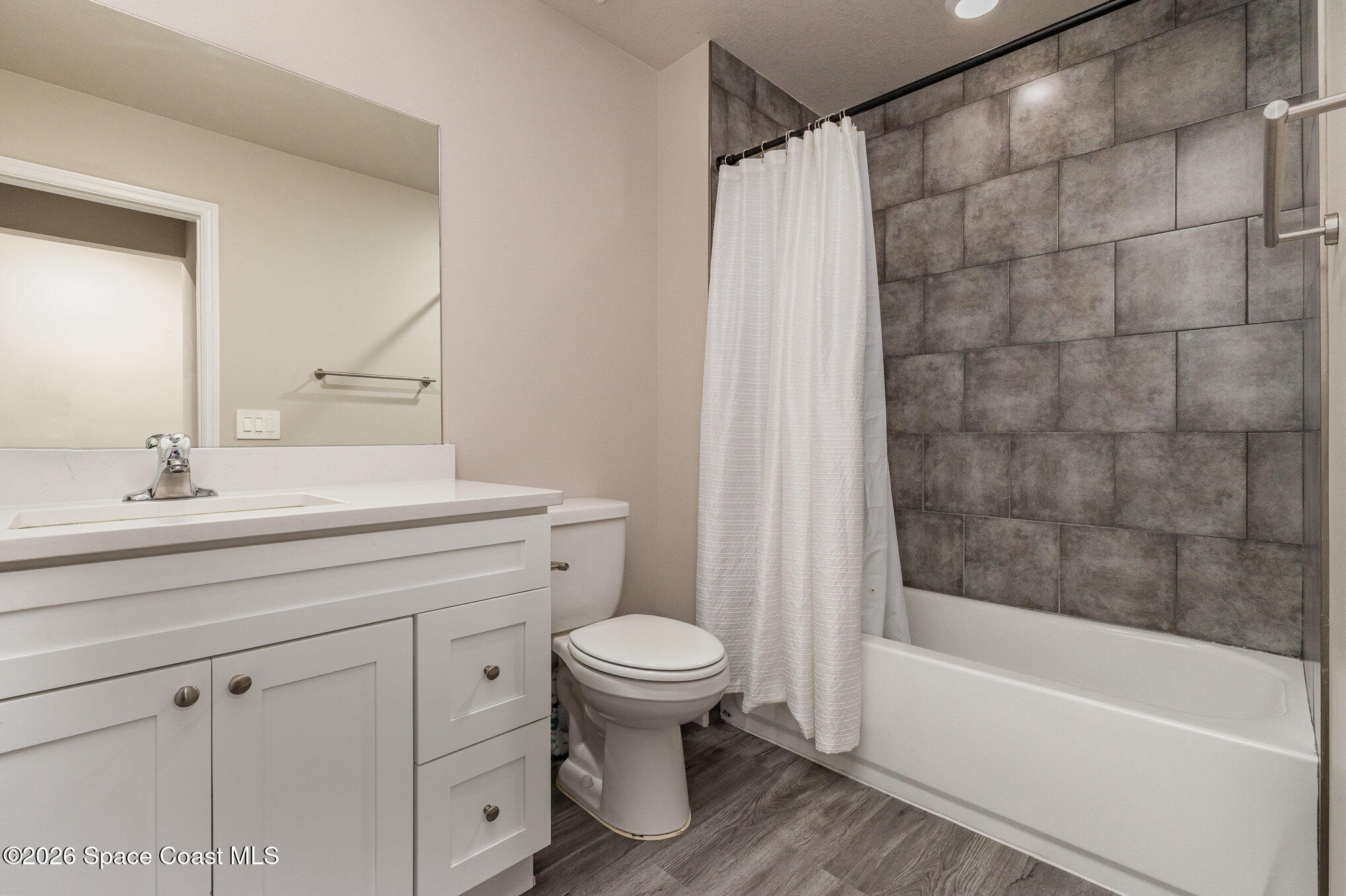 866 Carnival Road Southeast Palm Bay, FL 32909 - Photo 23 of 28 a bathroom with a sink a toilet and a bathtub