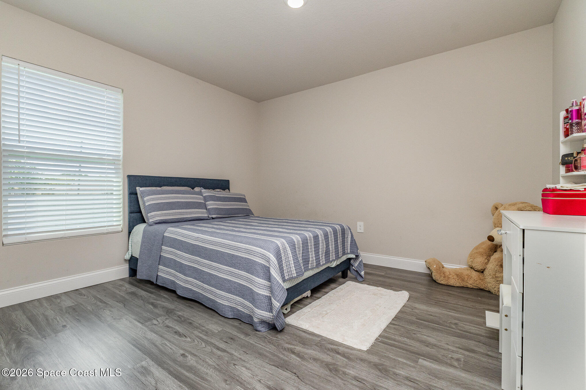 866 Carnival Road Southeast Palm Bay, FL 32909 - Photo 24 of 28 a bedroom with a bed and a window