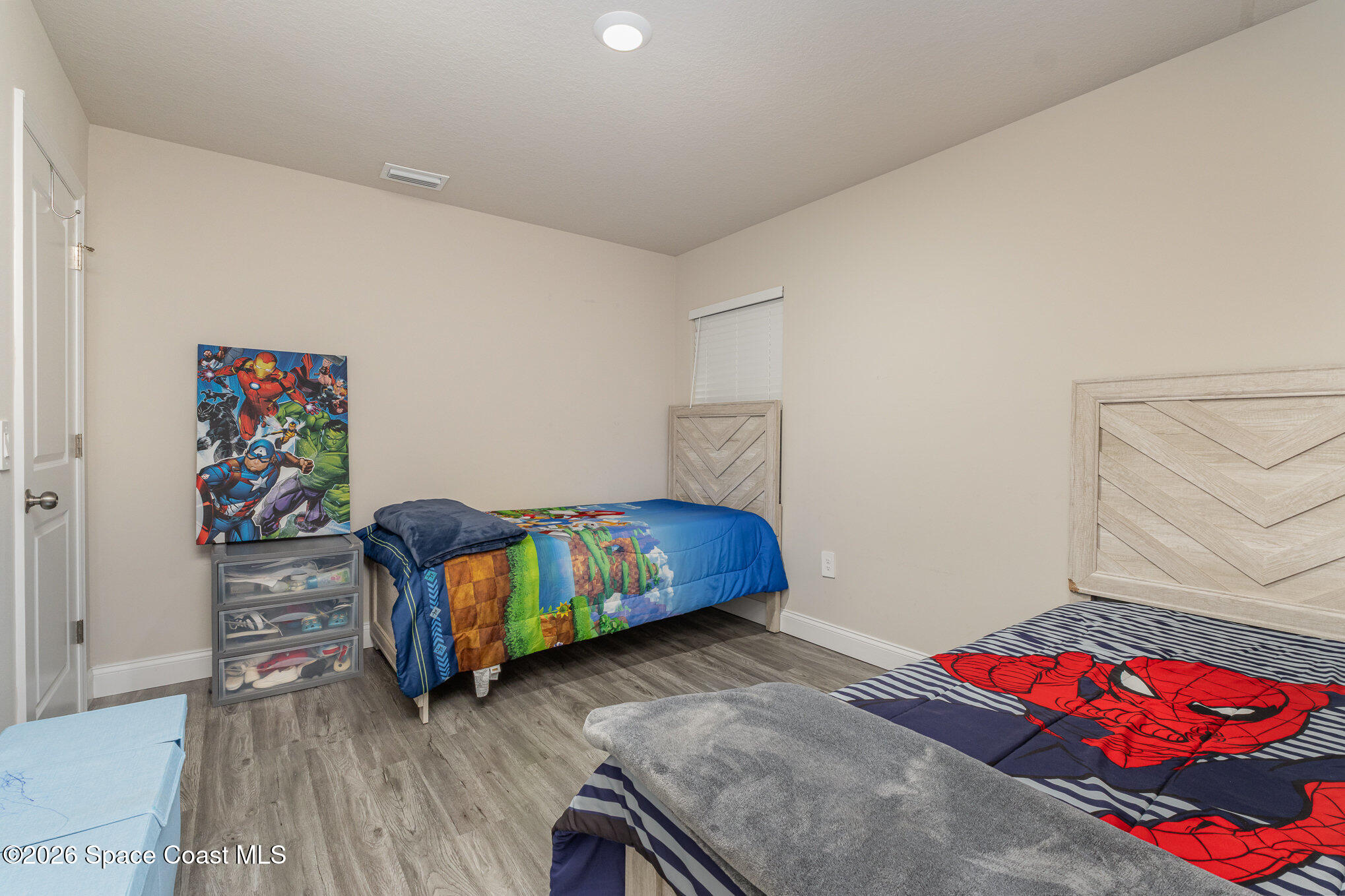 866 Carnival Road Southeast Palm Bay, FL 32909 - Photo 25 of 28 a bedroom with a bed and dresser
