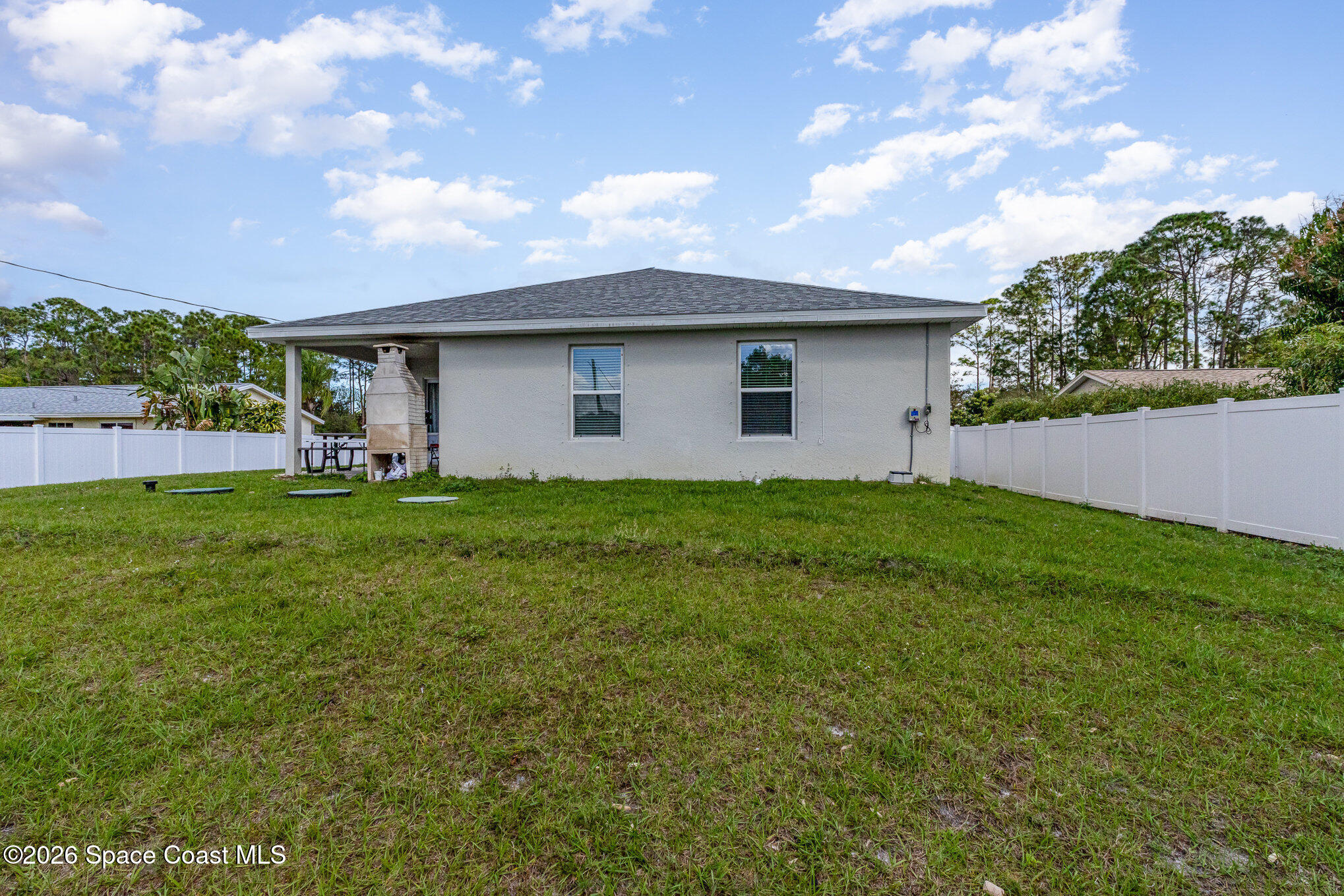 866 Carnival Road Southeast Palm Bay, FL 32909 - Photo 26 of 28 a backyard of a house with lots of green space