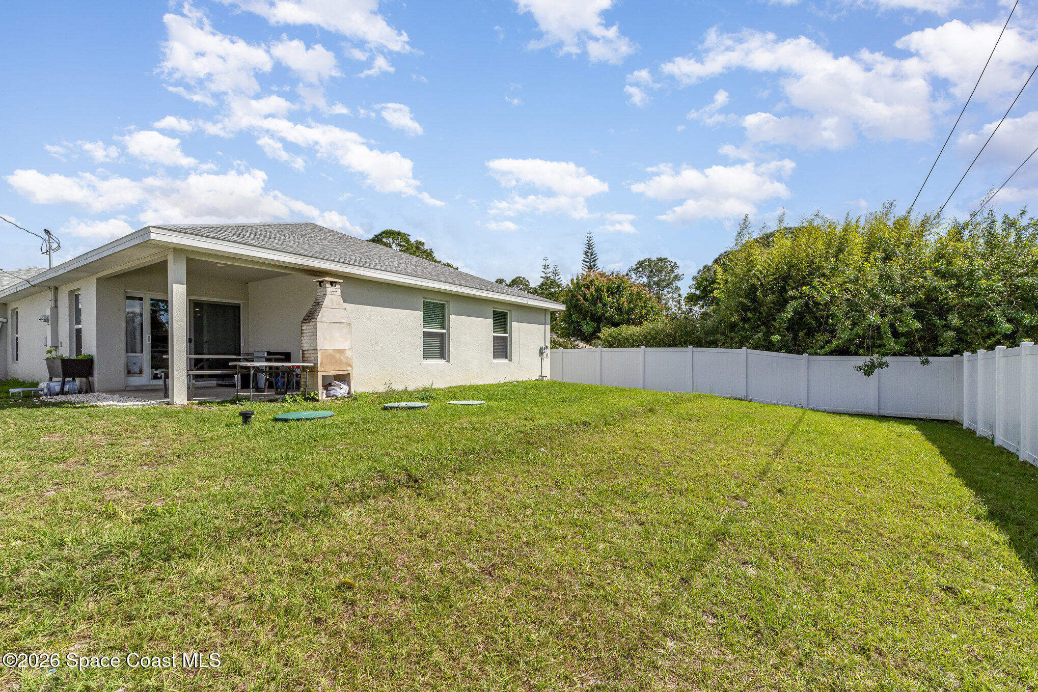 866 Carnival Road Southeast Palm Bay, FL 32909 - Photo 27 of 28 a view of a backyard with plants and a garden