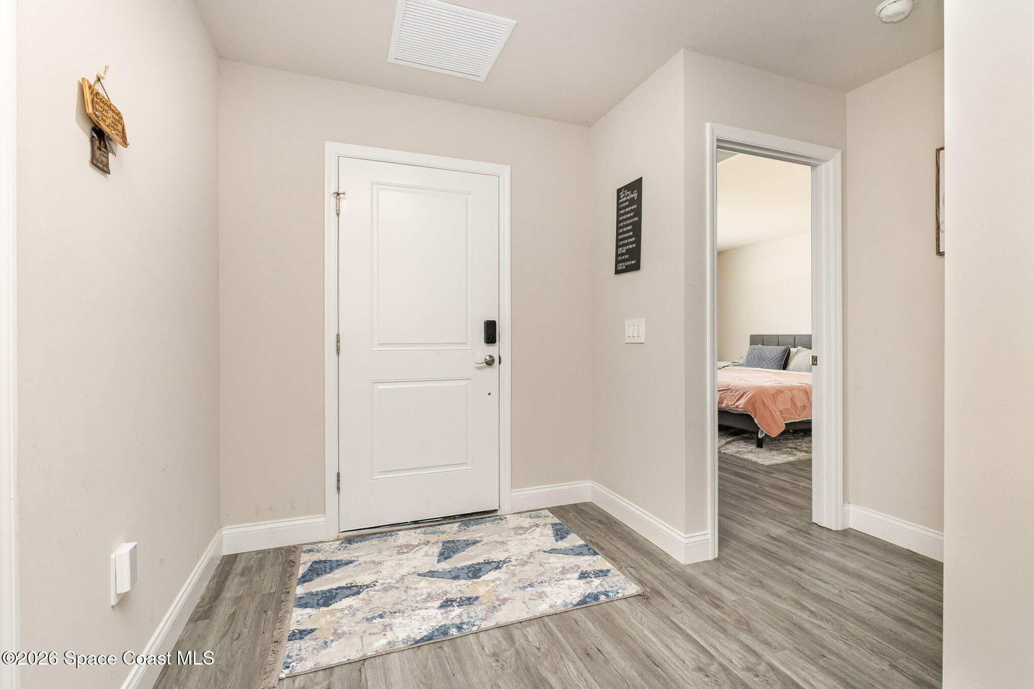 866 Carnival Road Southeast Palm Bay, FL 32909 - Photo 6 of 28 a bedroom with a bed and a walk in closet