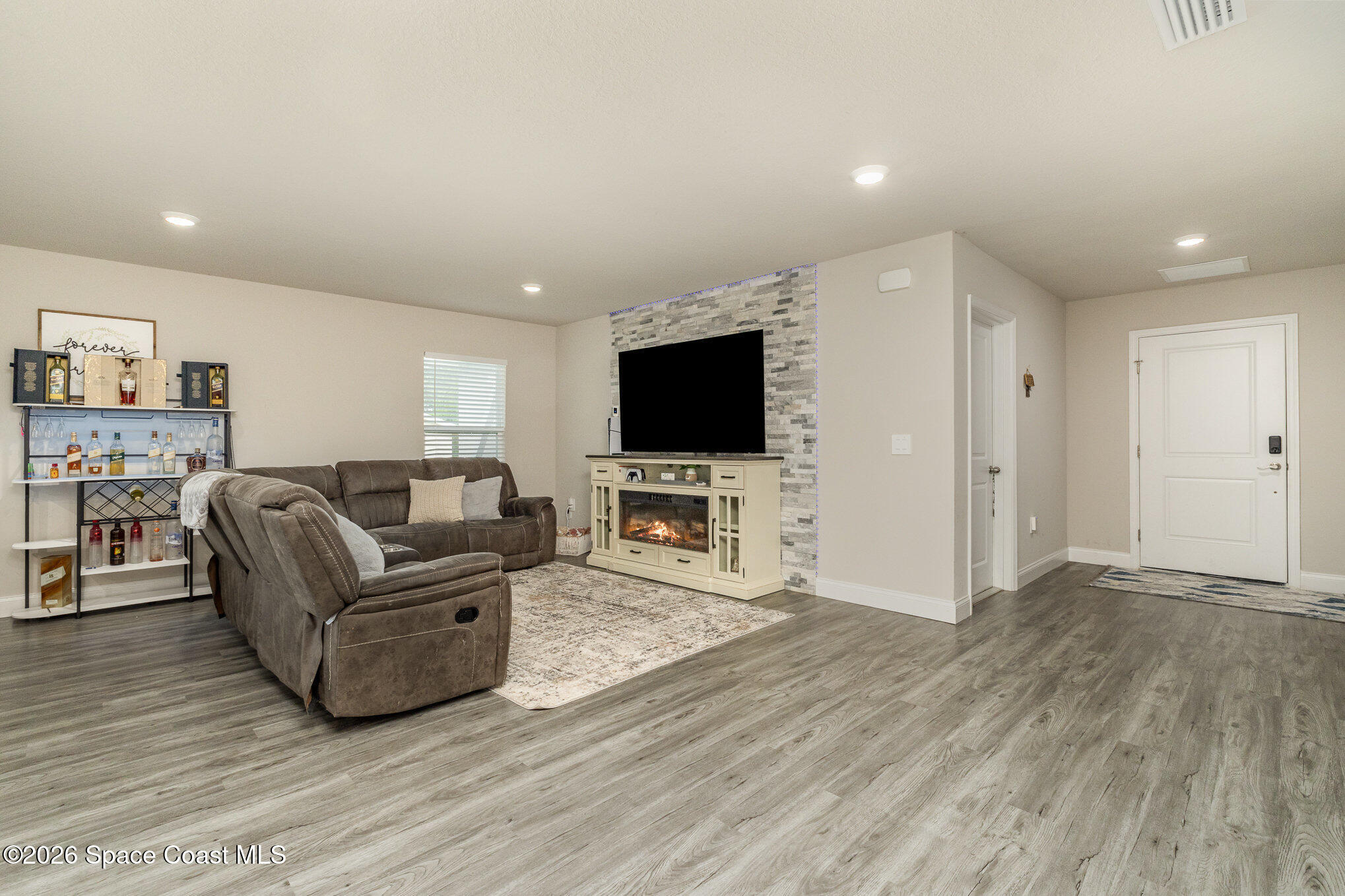866 Carnival Road Southeast Palm Bay, FL 32909 - Photo 7 of 28 a living room with furniture and a flat screen tv
