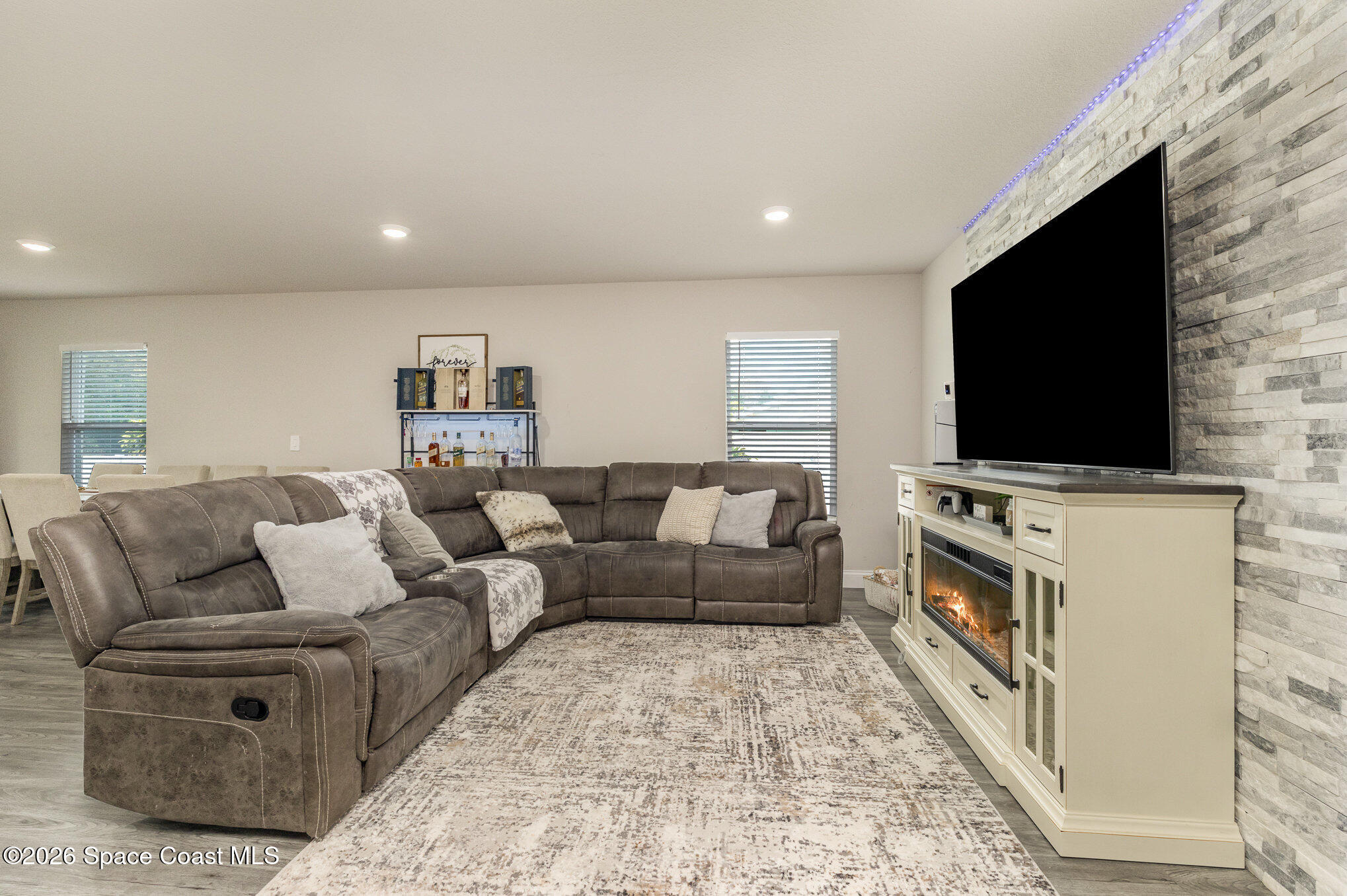 866 Carnival Road Southeast Palm Bay, FL 32909 - Photo 8 of 28 a living room with furniture and a flat screen tv