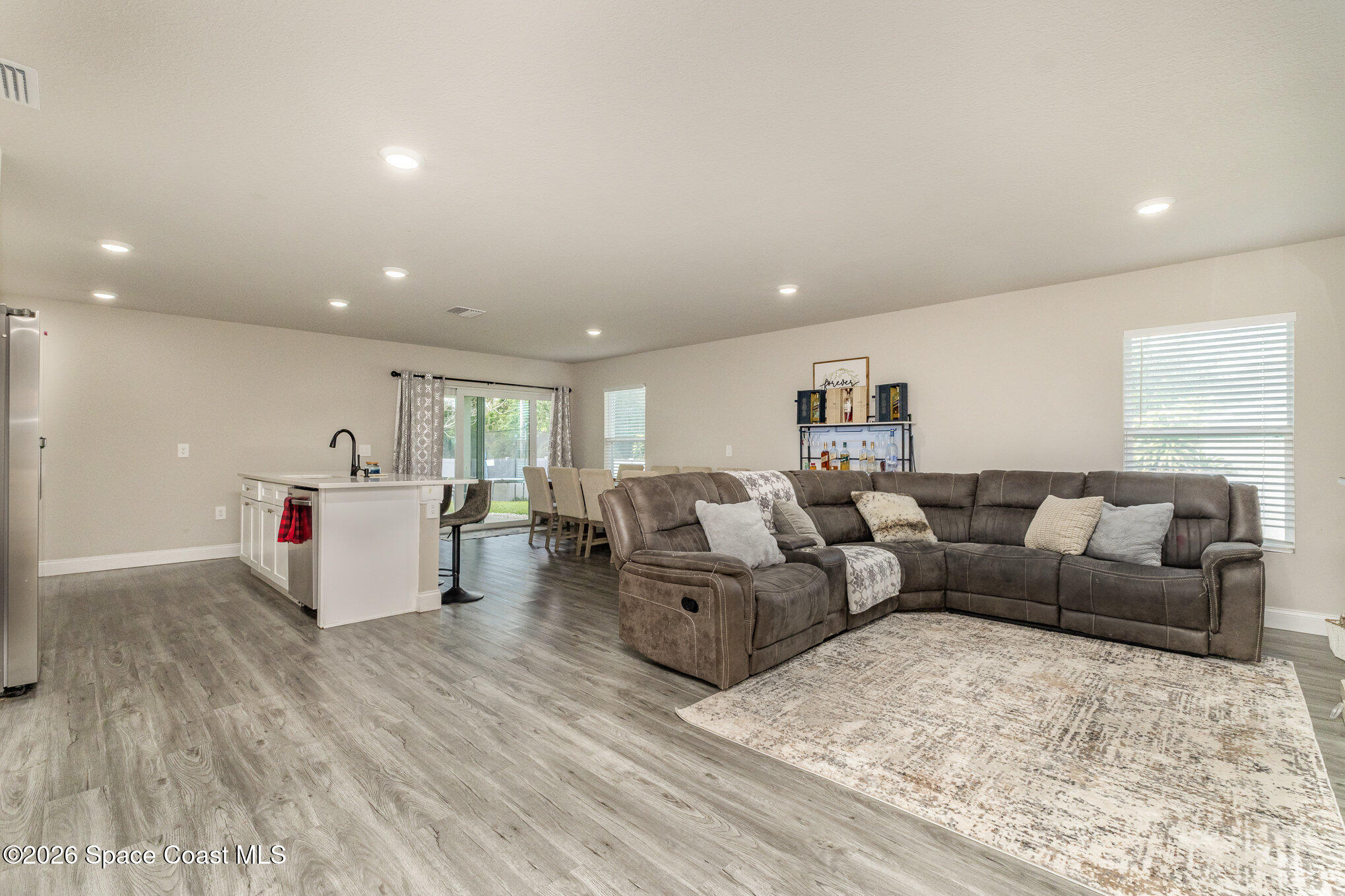 866 Carnival Road Southeast Palm Bay, FL 32909 - Photo 9 of 28 a living room with furniture and wooden floor