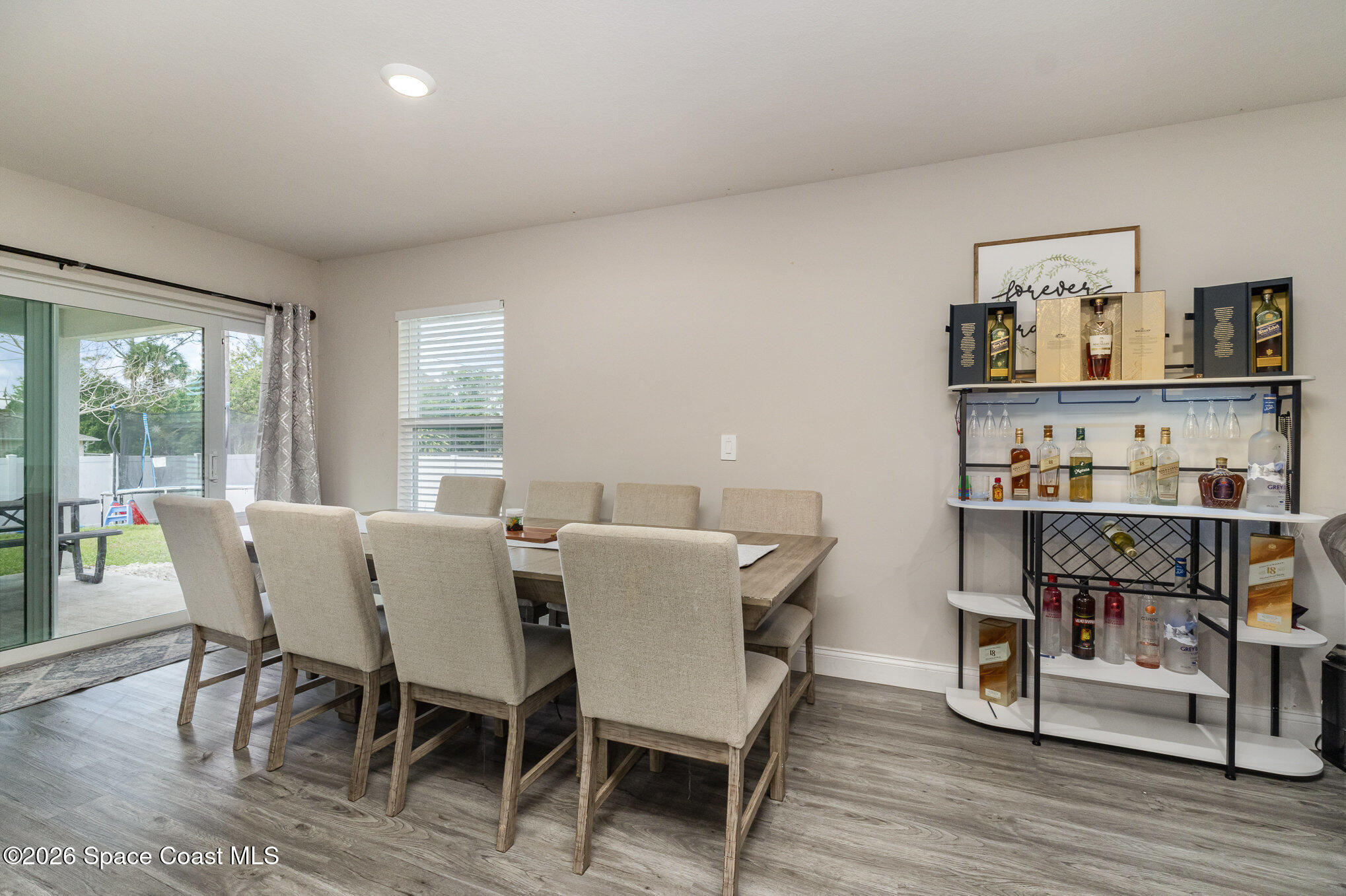 866 Carnival Road Southeast Palm Bay, FL 32909 - Photo 10 of 28 a view of a dining room with furniture and wooden floor