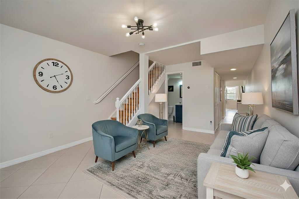 9500 Southwest 3rd Street, Unit 248 Boca Raton, FL 33428 - Photo 1 of 47 a living room with furniture and a clock