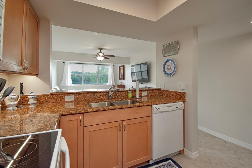 9500 Southwest 3rd Street, Unit 248 Boca Raton, FL 33428 - Photo 14 of 47 a kitchen with cabinets and window